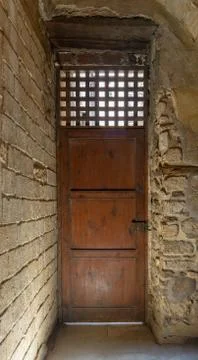 Facade of old abandoned stone bricks wall with one weathered wooden door Stock Photos