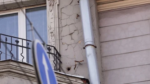 Facade of old beige beautiful building with several windows and balcony Stock Footage 107111362