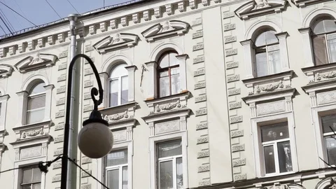 Facade of old beige massivel building with several windows and rain gutter pipe Stock Footage 107112226