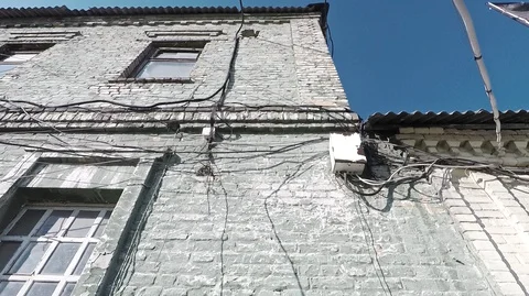 Facade of an old brick building covered with wires Stock Footage 124626207