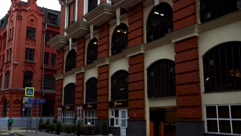 Facade of an old brick building of red color  street of the city. Footage. Stock Footage 127726309