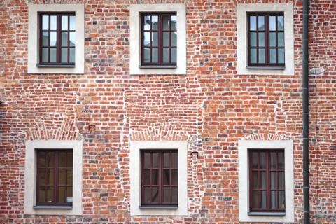 The facade of an old brick building with windows or cornices. Old brick walls Foto stock