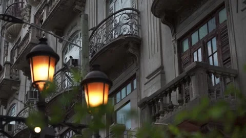 Facade of an old building with balconies in colonial style and illuminated Видео 274833447