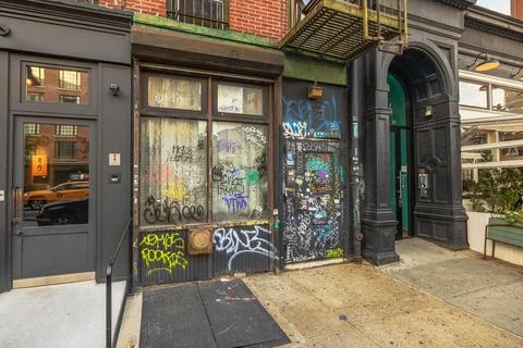 Facade of old building with graffiti covered door and windows in Chinatown Fotos de archivo
