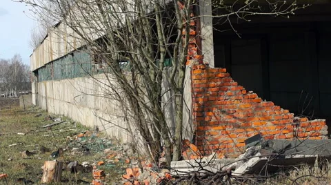 Facade of an old building with no windows on the background of plants Video stock 57322791