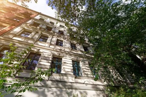 The facade of an old building with some windows closed by blinds Stock Photos