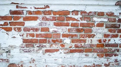 The facade of an old building. Texture of a red brick wall. Background painte Stock Photos