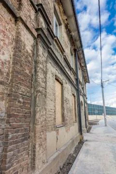Facade of an old devastated brick building Stock Photos