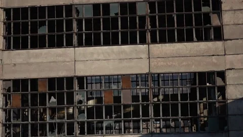 Facade of an old dilapidated building of an industrial plant with broken glass Stock Footage 224743456