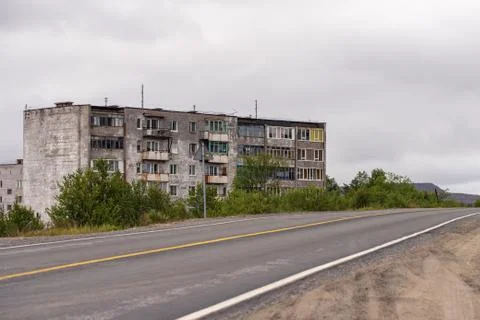 Facade of old grey multi-storey soviet panel building Stock Photos
