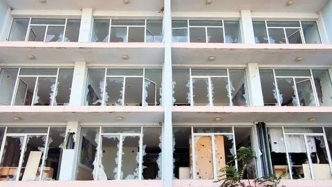 Facade of an old hotel with broken windows Stock Photos
