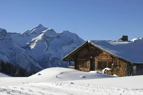 Facade of a old timber mountain hut and Mount Oldehore Stock Photos