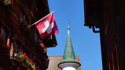 Facade on an Old Typical Beautiful Mountain Wood House with the Swiss Flag Stockbeeldmateriaal 284918850