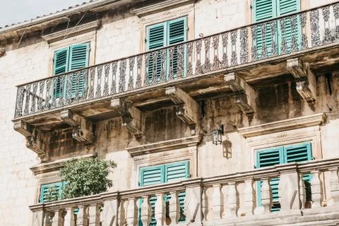 The facade of an ordinary old building with windows and balconies in Montenegro. Stock Photos