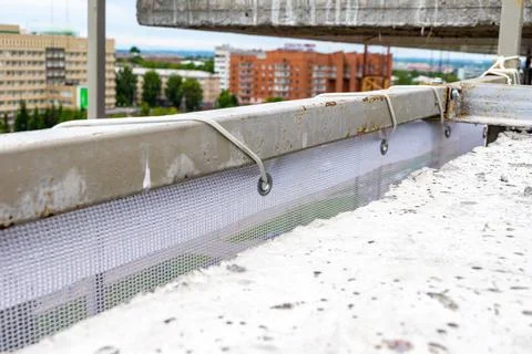 Facade protective mesh stretched over a steel frame for fencing scaffolding Stock Photos
