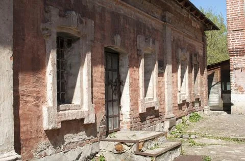 The facade is red brick with windows Stock Photos