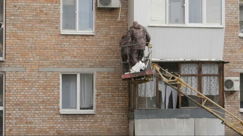 Facade Repair Work Using Telescopic Boom Lifting Platform Stock Footage 195005887