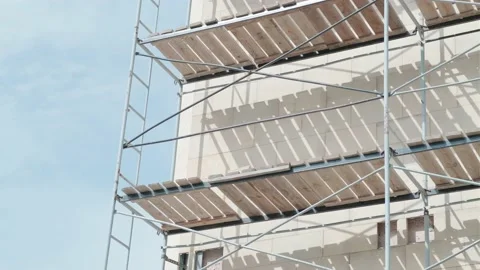 Facade restoration of building against cloudy sky. Reconstruction of building Vídeos de archivo 206384186
