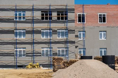 Facade restoration work. Scaffolding in front of the facade. Building under c Stock Photos