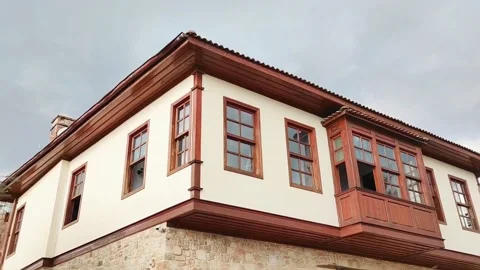 The facade of a restored old building with windows in decorative frames Stock Footage 236396207