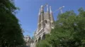 The facade of Sagrada Familia seen behind trees in Barcelona 4k or 4k+ Resolution