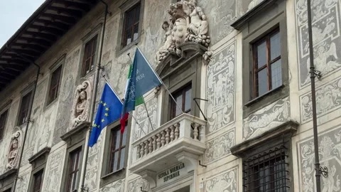 Facade of Scuola Normale Superiore with EU and institutional flags in Pisa Stock Footage 308241531