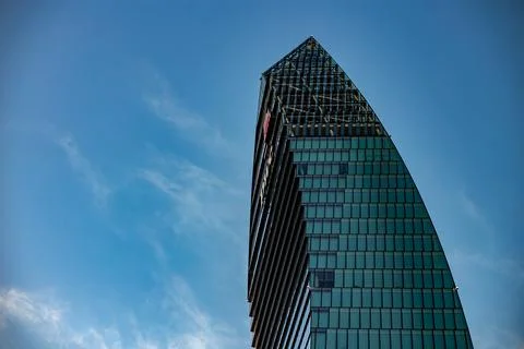 Facade of a skyscraper against a background of blue sky. Milano City Life Stock Photos
