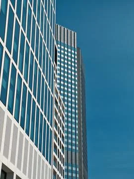 A facade of a skyscraper with large windows and a blue sky 写真素材