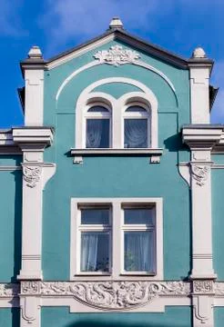 Facade with stucco elements of an old house Stock Photos