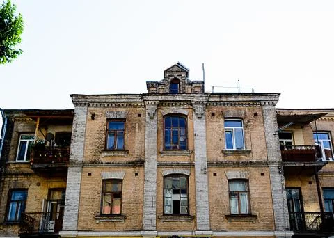 Facade of the three-storey red brick building Stock Photos