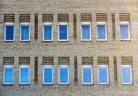 Facade of the two-storey white brick building Stock Photos