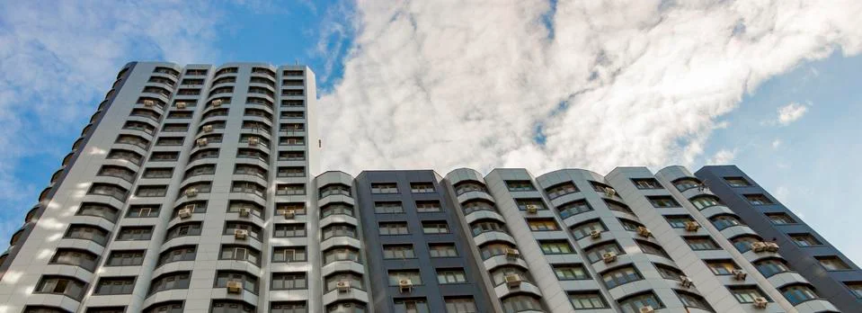 The facade of a typical block multi-storey residential building. Front view Stock Photos