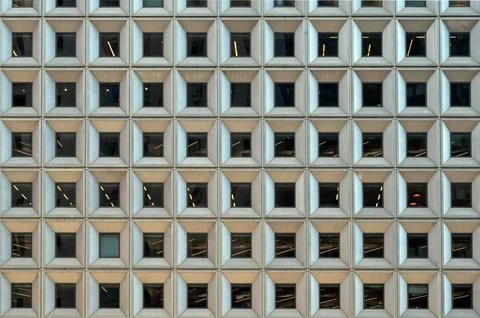 Facade of urban skyscraper rows of square geometric pattern windows Foto stock
