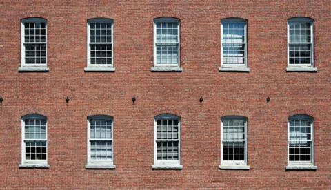 Facade view of brick wall and window of old factory building Stock Photos