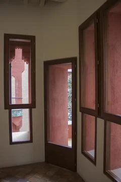 Facade wall with decorative, red windows Stock Photos