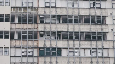 Facade of a war attack damaged building revealing its structural elements Stock Footage 310333972