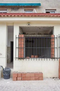 Facade with a window of a house under construction Stock Photos
