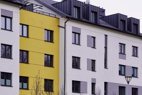 Facade of windows in attic or loft housing or office. Apartments under the ro Stock Photos