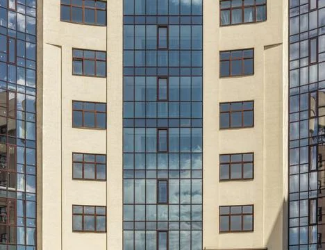 Facade windows of modern multi-storey brown beige building in the city. Space Stock Photos