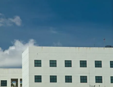 Facade windows of office building on blue sky Stock Photos