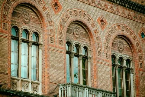 Facade of the windows of the old building, ancient architecture, arched windows Stock Photos