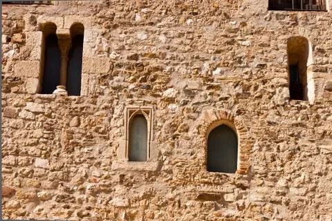 Facade with windows in the romanesque monastery of Sant Cugat Stock Photos