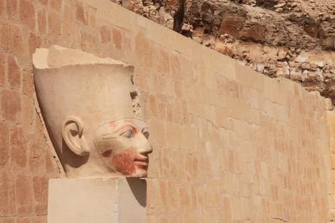 Face in ancient stone column Stock Photos