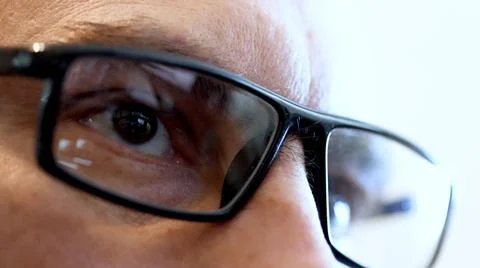 Face and reflection of the tablet screen in glasses. Stock Photos