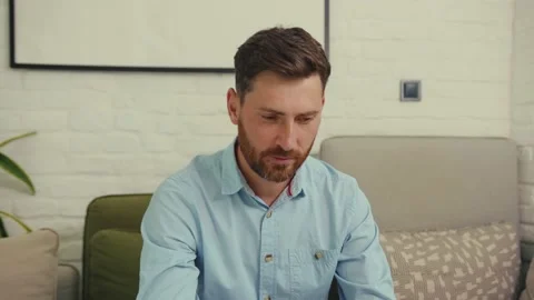 Face attractive man looking at camera smiling happy worker laptop sitting on Stock Footage 132541517