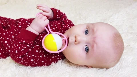 Face of baby boy lying on back and playing Stock Footage 167216514