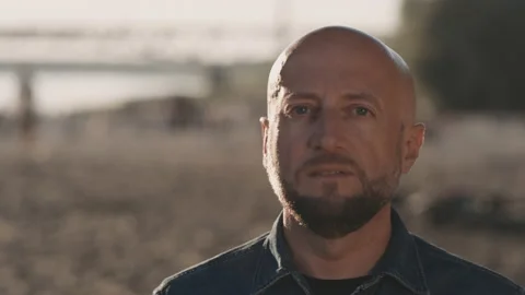 Face of bald and handsome man with a stylish beard who is s standing on the Stock Footage 140132849