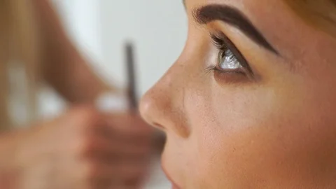 Face beautiful woman while application smoky eyes make up for beauty contest Stock Footage 91484815