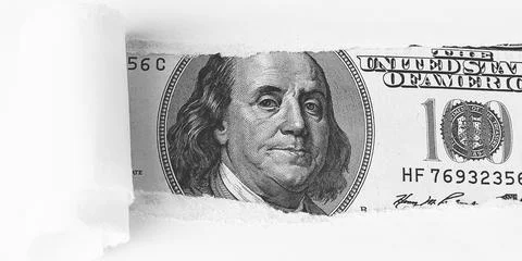 The face of Benjamin Franklin on a hundred-dollar bill, from a torn window in Stock Photos