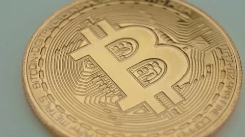The face of the bitcoin coin is spinning on the platform. Stock Footage 151111984